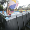 24-foot Intex above-ground pool set with sturdy frame, included ladder, and filtration pump for backyard use.