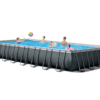 Intex 26374 rectangular above-ground pool set with accessories, including ladder, sand filter pump, pool cover, ground cloth, and plumbing components.