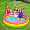 Colorful inflatable kiddie pool with three vibrant rings and a soft inflatable base, suitable for toddlers.