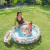 Colorful inflatable kiddie pool with tropical fruit, flamingo, and summer-themed prints, including matching ball and float ring.