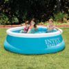 Inflatable round backyard pool by Intex, filled with clear water and featuring a white top ring and blue body.