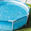 Above ground circular swimming pool by Intex with steel frame and mesh liner, filled with water.