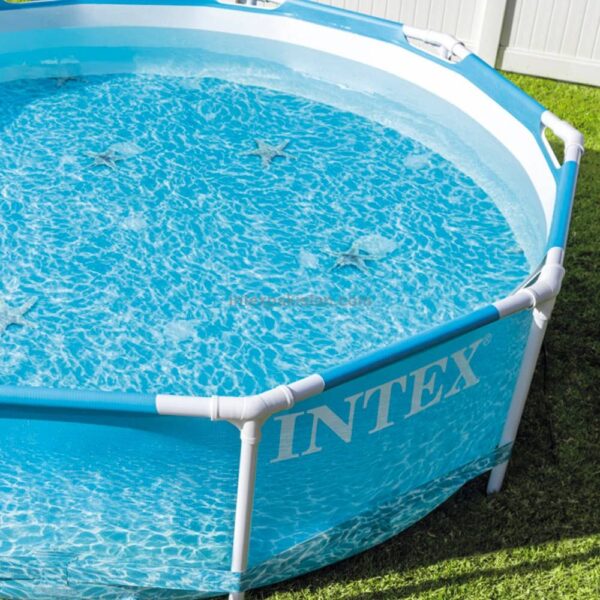 Above ground circular swimming pool by Intex with steel frame and mesh liner, filled with water.